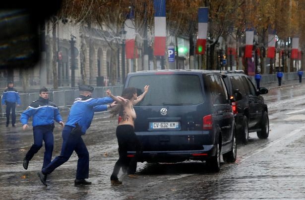 Photos &Video: Topless woman runs at President Trump
