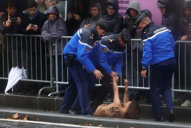 Photos &Video: Topless woman runs at President Trump