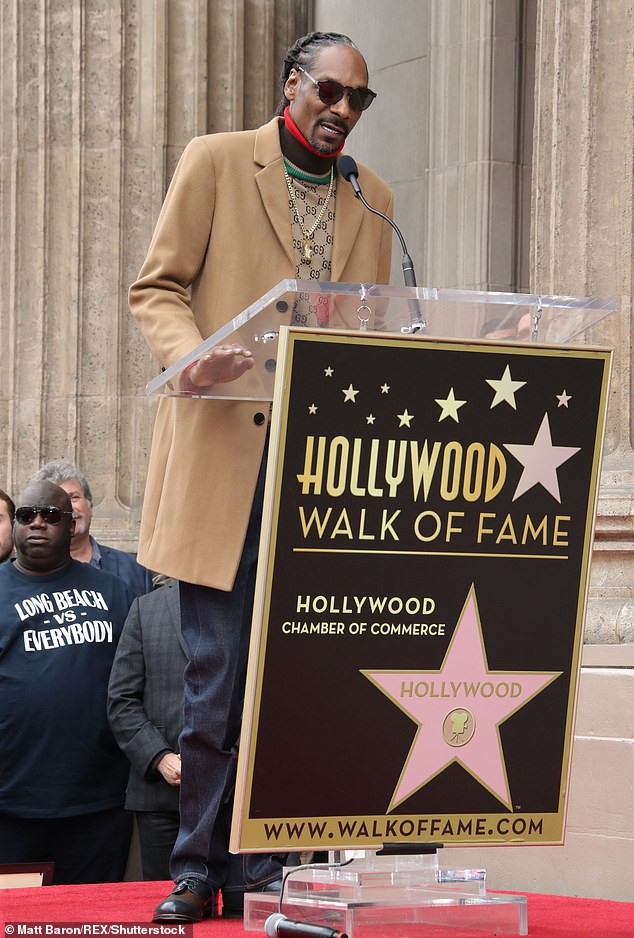 Snoop Dogg plants a sweet kiss on his wife of 21-years as he gets a star on Hollywood Walk of Fame (Photos)