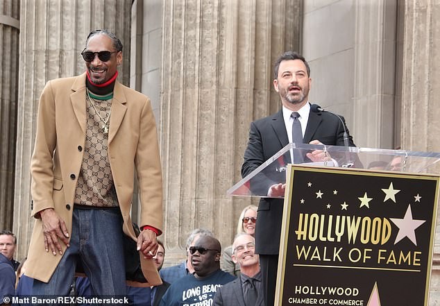 Snoop Dogg plants a sweet kiss on his wife of 21-years as he gets a star on Hollywood Walk of Fame (Photos)