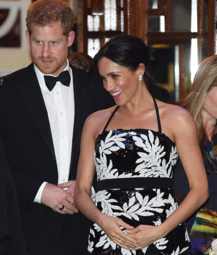 The pregnancy glow! Meghan Markle cradles her bump as she and Prince Harry enjoyed a night out (photos)