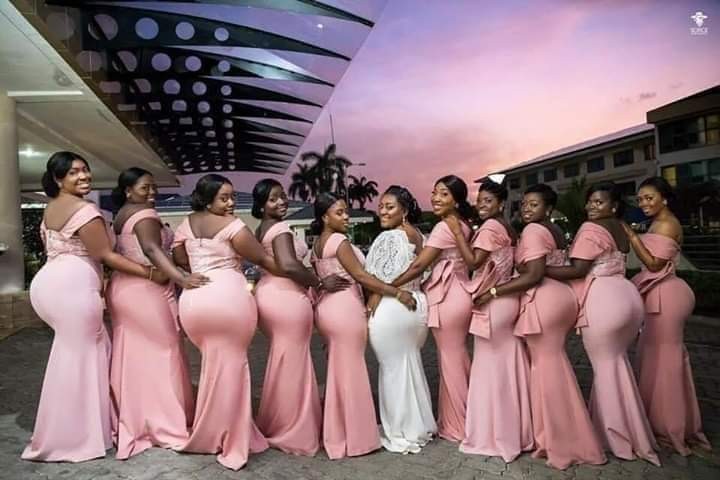 Check out this striking photo of a bride and her bridesmaids flaunting their massive backsides