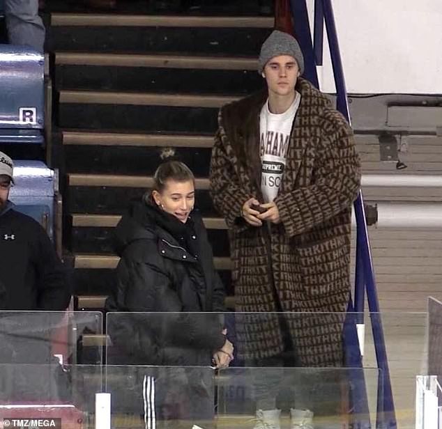 Justin Bieber and wife Hailey Baldwin cuddle up at a junior hockey game in Canada (Photos)