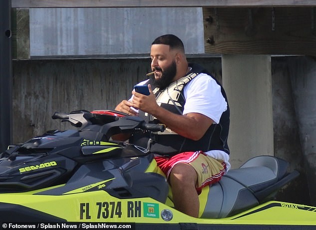 DJ Khaled and his wife Nicole Tuck ride jet skis around Miami on his 43rd birthday (Photos)
