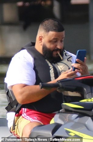 DJ Khaled and his wife Nicole Tuck ride jet skis around Miami on his 43rd birthday (Photos)