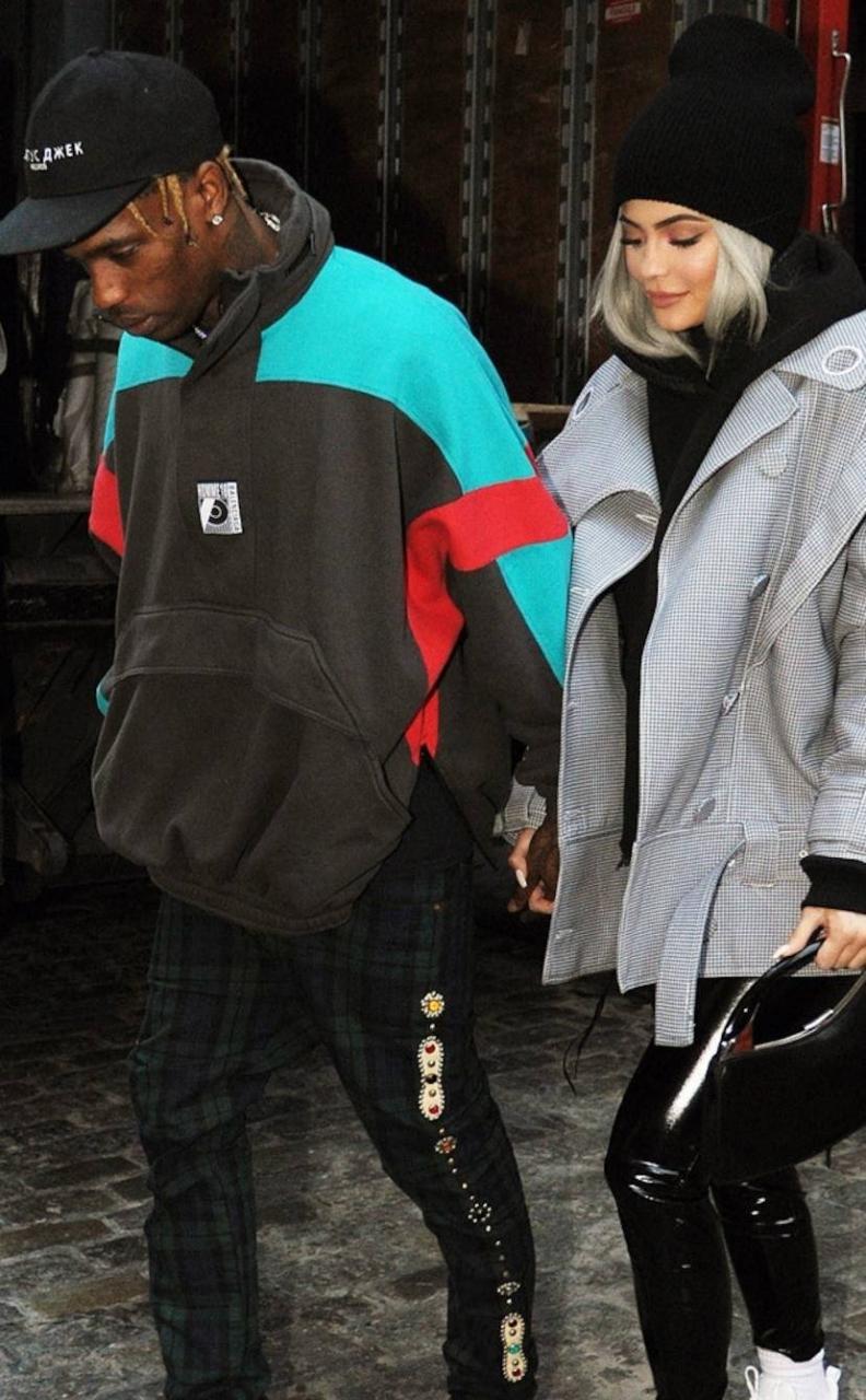 Travis Scott denies cheating rumors after someone who looks exactly like him was photographed cuddling a woman who isn