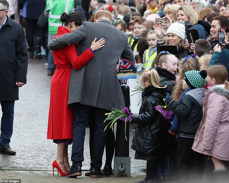 Meghan Markle lets slip her baby will arrive in April as she and Harry arrive in Birkenhead 