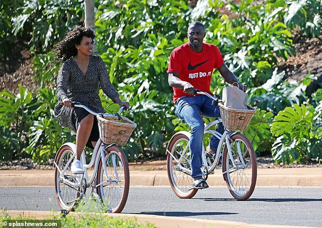 Idris Elba enjoys a romantic bike ride with his stunning fianc?e Sabrina Dhowre during their Hawaii break (Photos)