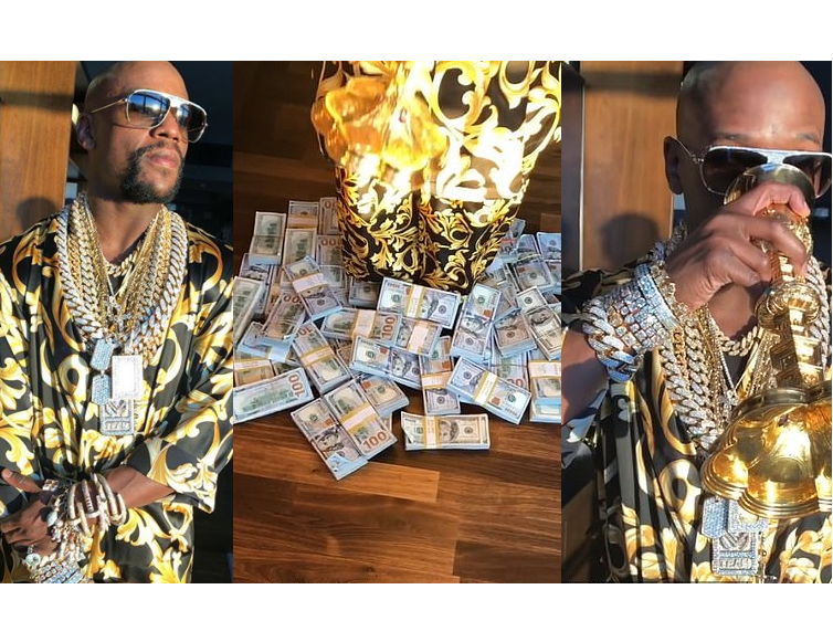 Floyd Mayweather flaunts lavish lifestyle with piles of cash and diamond jewellery as he sips from a gold goblet (Video)