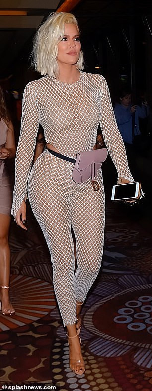Khloe Kardashian flaunts her curves in a skintight fishnet catsuit as she steps out for her best friend