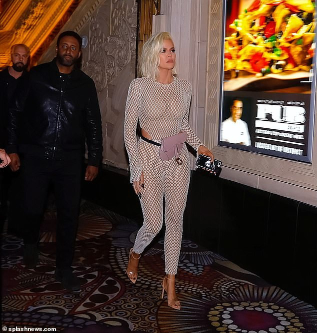 Khloe Kardashian flaunts her curves in a skintight fishnet catsuit as she steps out for her best friend