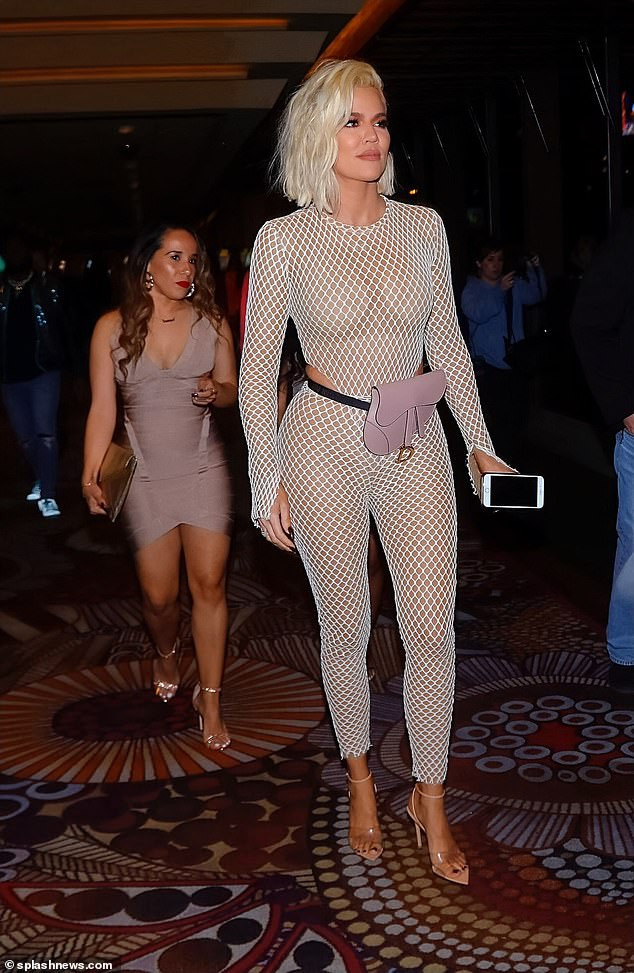 Khloe Kardashian flaunts her curves in a skintight fishnet catsuit as she steps out for her best friend
