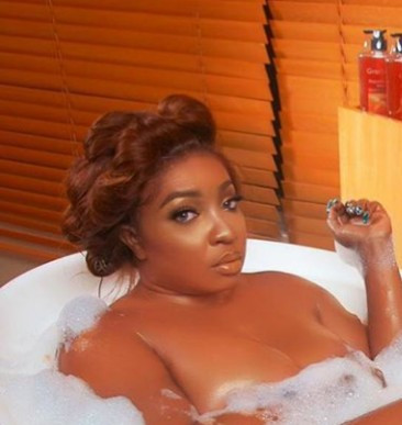 Anita Joseph soaks naked in a bathtub