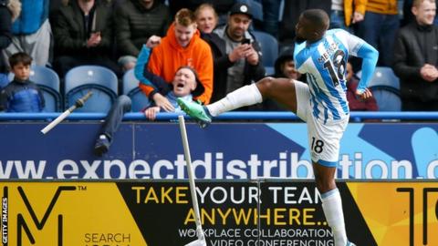 Huddersfield's Isaac Mbenza breaks the corner flag after scoring against Manchester United
