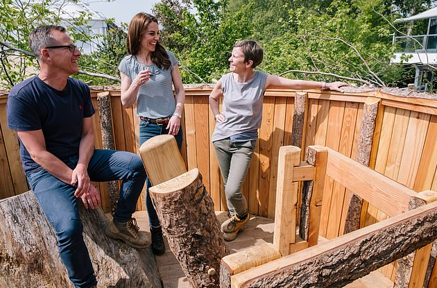 Kate Middleton shows off her playful side as she poses in the garden she designed for the Chelsea Flower Show