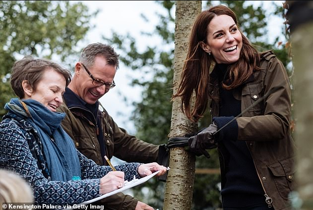 Kate Middleton shows off her playful side as she poses in the garden she designed for the Chelsea Flower Show