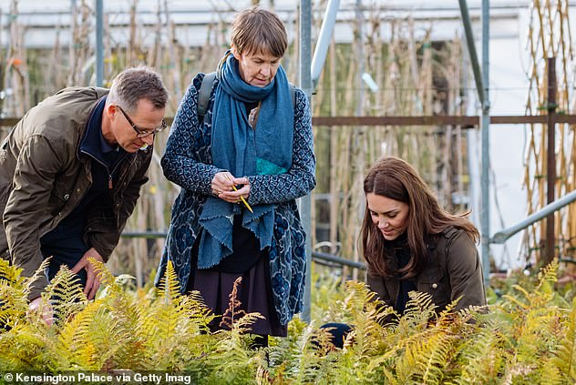 Kate Middleton shows off her playful side as she poses in the garden she designed for the Chelsea Flower Show