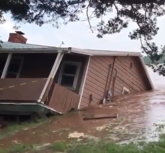 Watch as erosion caused by flooding sweeps home into river