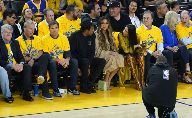 Woman leaning over Beyonce at game shares photo of her and Bey to show they are good but the Beyhive are not appeased
