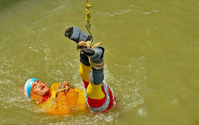 Update: Indian stuntman who was lowered into the river while tied up is feared dead as first images of the stunt emerge ?(Photos)