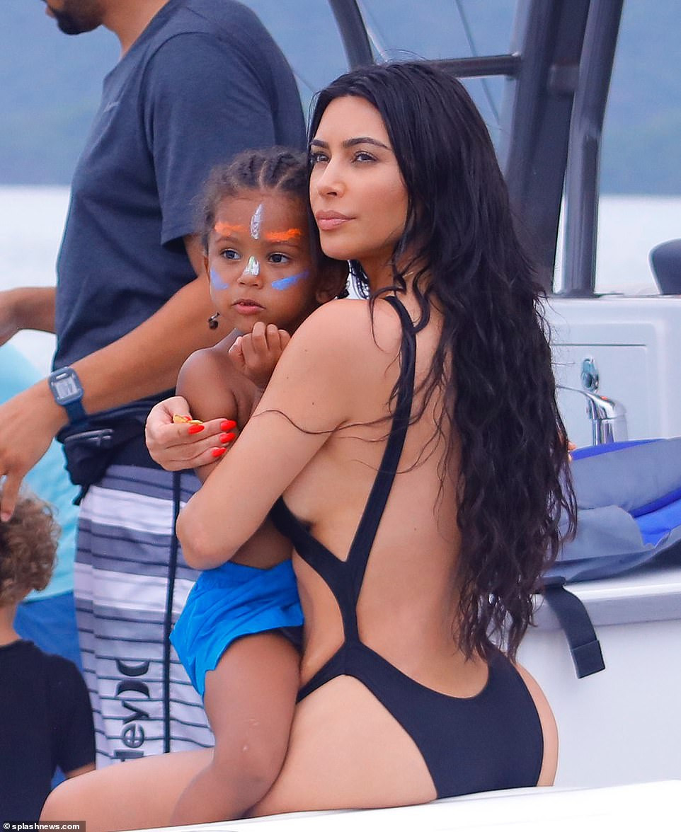 Kim Kardashian flaunts her famous backside in skimpy black swimsuit during boat day in Costa Rica (Photos)