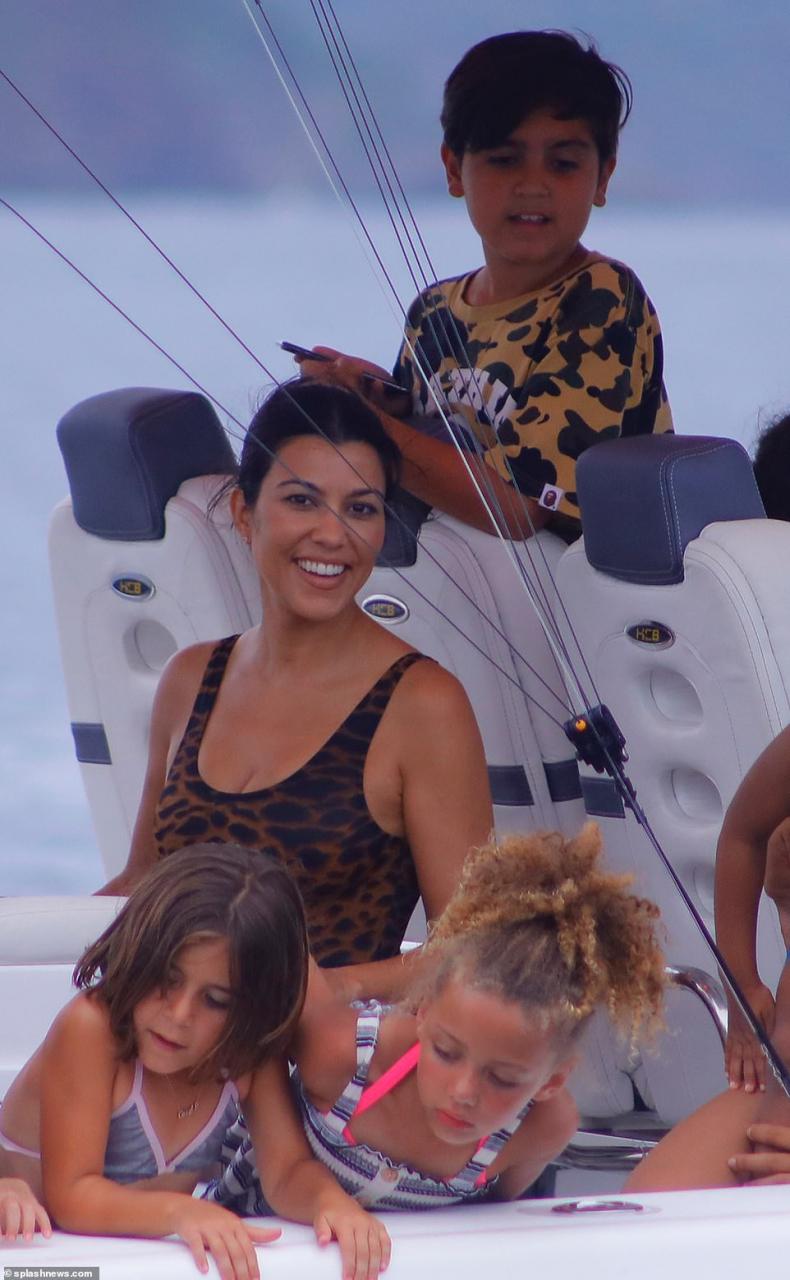 Kim Kardashian flaunts her famous backside in skimpy black swimsuit during boat day in Costa Rica (Photos)