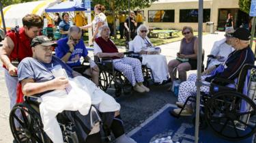 Evacuated patients rest under a shade of tent after being evacuated from Ridgecrest Regional Hospital