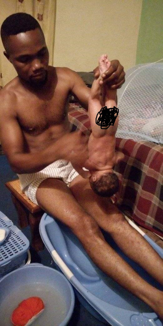 Photos of a Nigerian man bathing his newborn baby