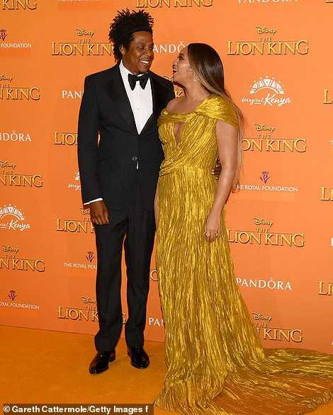 Beyonc? commands attention in a gold asymmetric gown as she joins husband Jay-Z at London