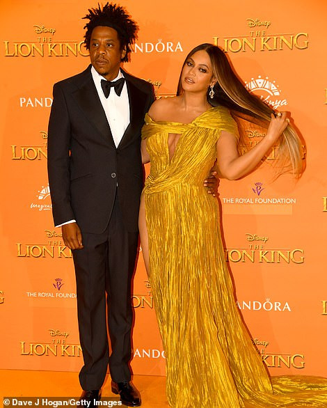 Beyonc? commands attention in a gold asymmetric gown as she joins husband Jay-Z at London