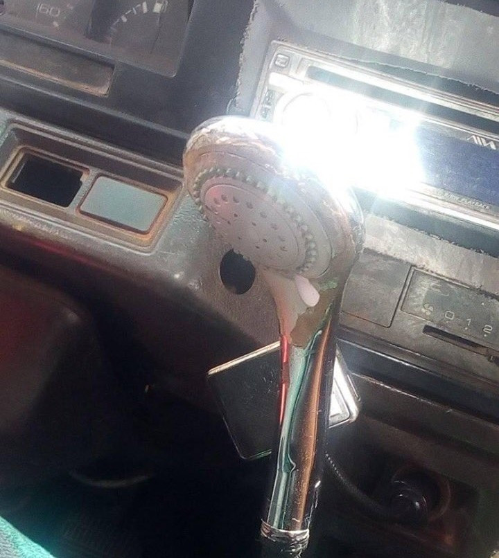 Bus driver seen using a shower head as a gear stick in Lagos