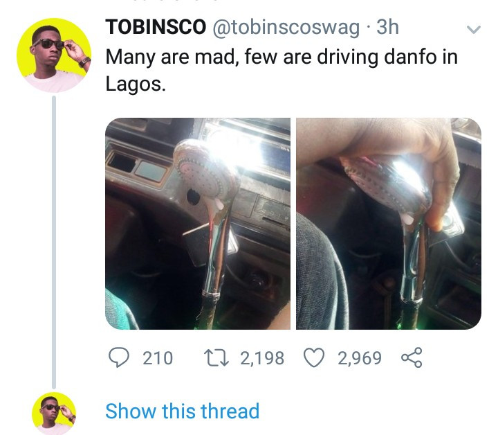 Bus driver seen using a shower head as a gear stick in Lagos