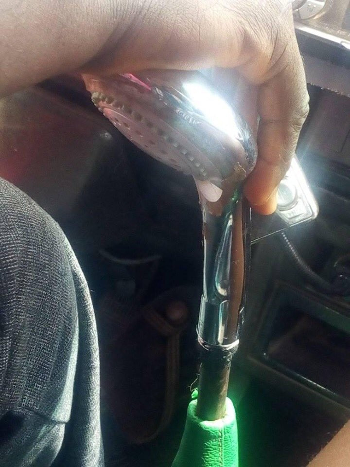 Bus driver seen using a shower head as a gear stick in Lagos