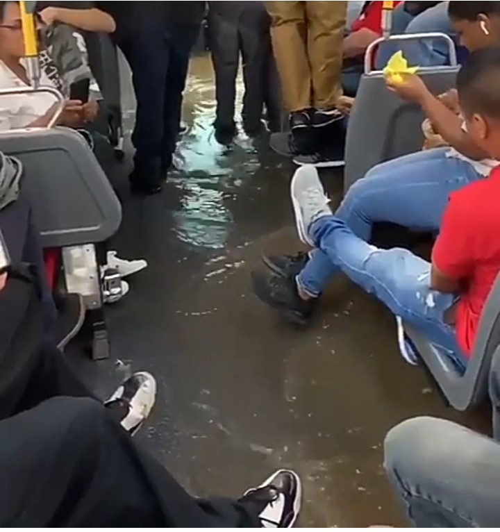 New York City bus passengers struggle to stay dry as their bus gets flooded due to rainy weather (video)
