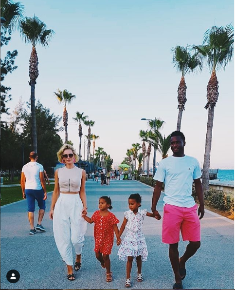 Mikel Obi enjoys a stroll with his Russian partner and their beautiful twin daughters