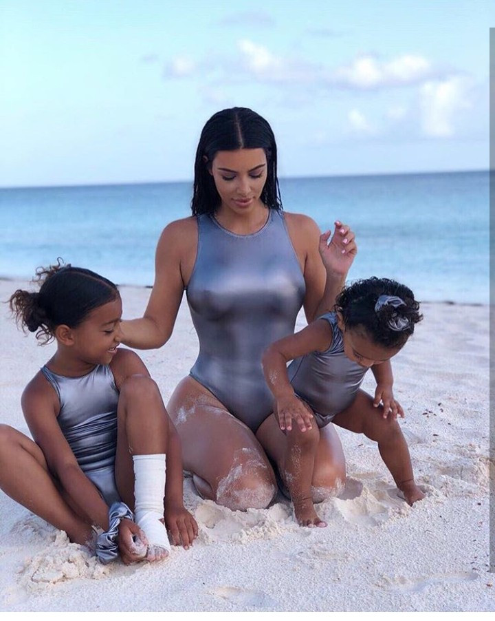 Kim Kardashian shares adorable photos of her and her kids on vacation as she talks about how hard it is to get them to pose for photos