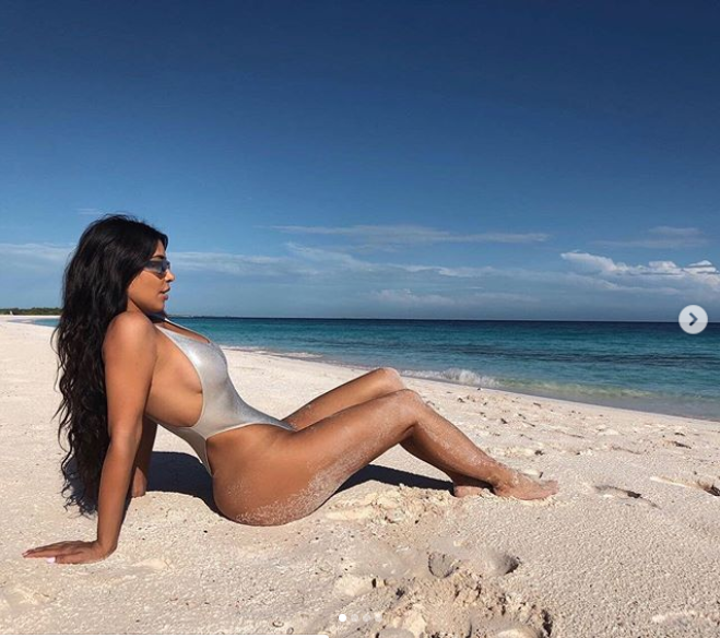 Kim Kardashian poses up a storm in a sexy silver metalic swimsuit (Photos)
