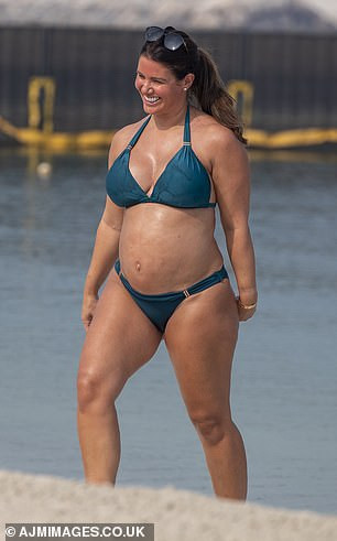 Rebekah Vardy flaunts her blossoming bump as she kisses her husband Jamie Vardy in the sea in Dubai (Photos)