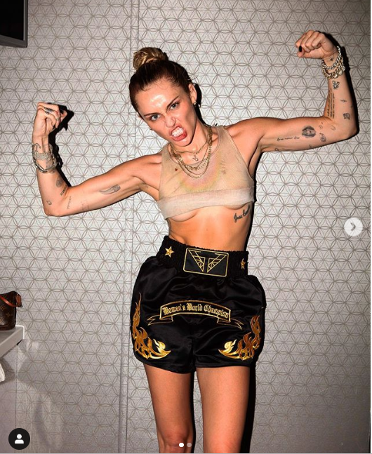 Miley Cyrus flaunts underboobs as she flexes her muscles in new photos