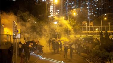 Demonstrators flee from tear gas in Hong Kong