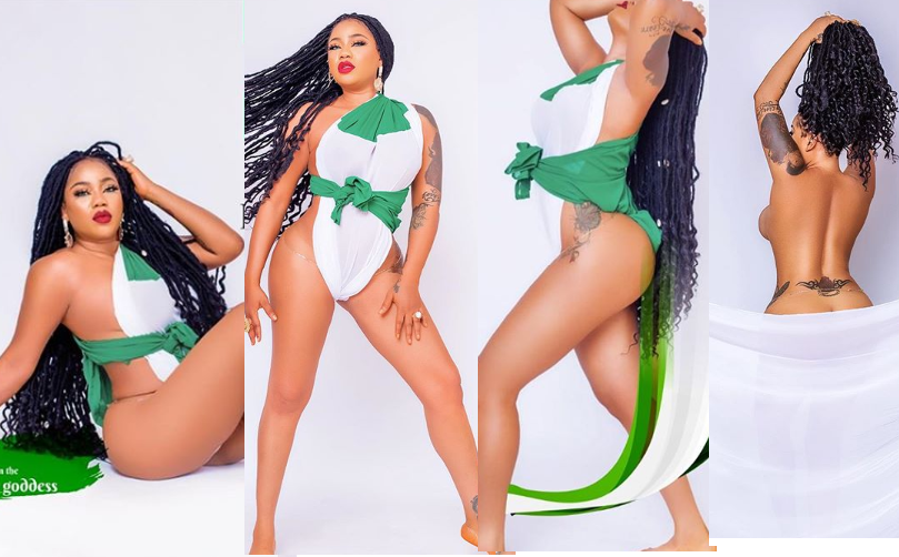 Toyin Lawani barely covers her body with a green and white piece of material to mark Nigeria