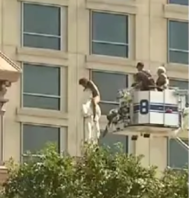 Stark naked woman climbs the roof of a cathedral and straddles statue for more than 4 hours (video)