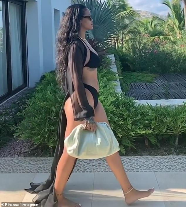 Rihanna showcases her bikini body in sexy black bathing suit with sheer cover-up (Photos/Video)