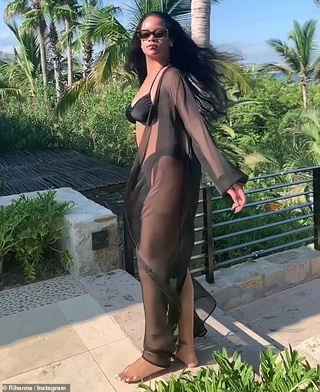Rihanna showcases her bikini body in sexy black bathing suit with sheer cover-up (Photos/Video)