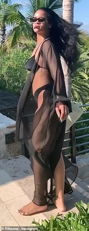 Rihanna showcases her bikini body in sexy black bathing suit with sheer cover-up (Photos/Video)