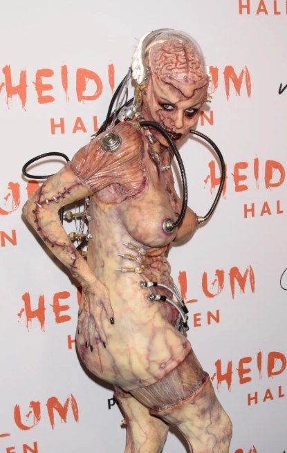 Heidi Klum beats her previous record as she reveals her gory Halloween costume after 13 hours of prosthetics   