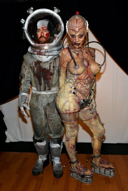 Heidi Klum beats her previous record as she reveals her gory Halloween costume after 13 hours of prosthetics   