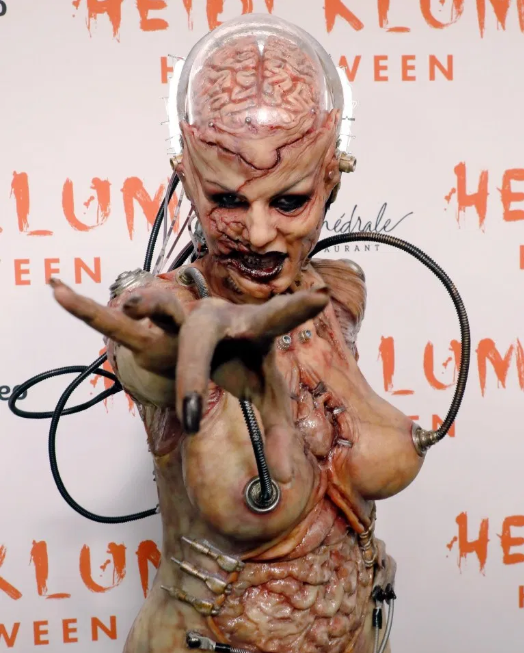 Heidi Klum beats her previous record as she reveals her gory Halloween costume after 13 hours of prosthetics   