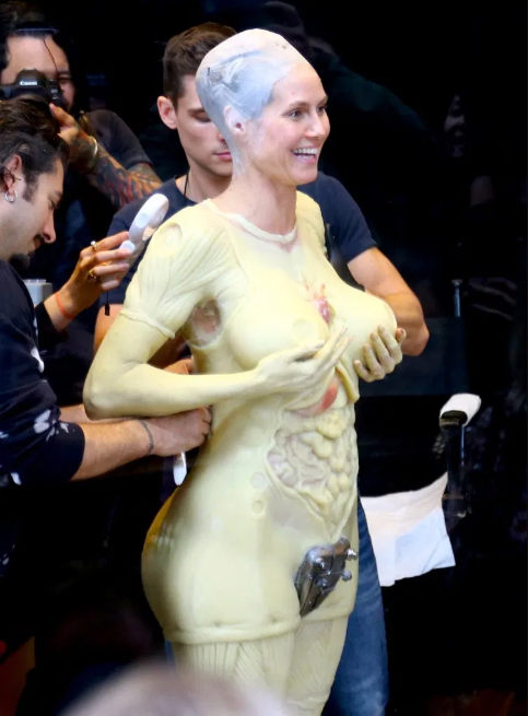 Heidi Klum beats her previous record as she reveals her gory Halloween costume after 13 hours of prosthetics   