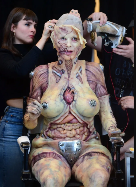 Heidi Klum beats her previous record as she reveals her gory Halloween costume after 13 hours of prosthetics   